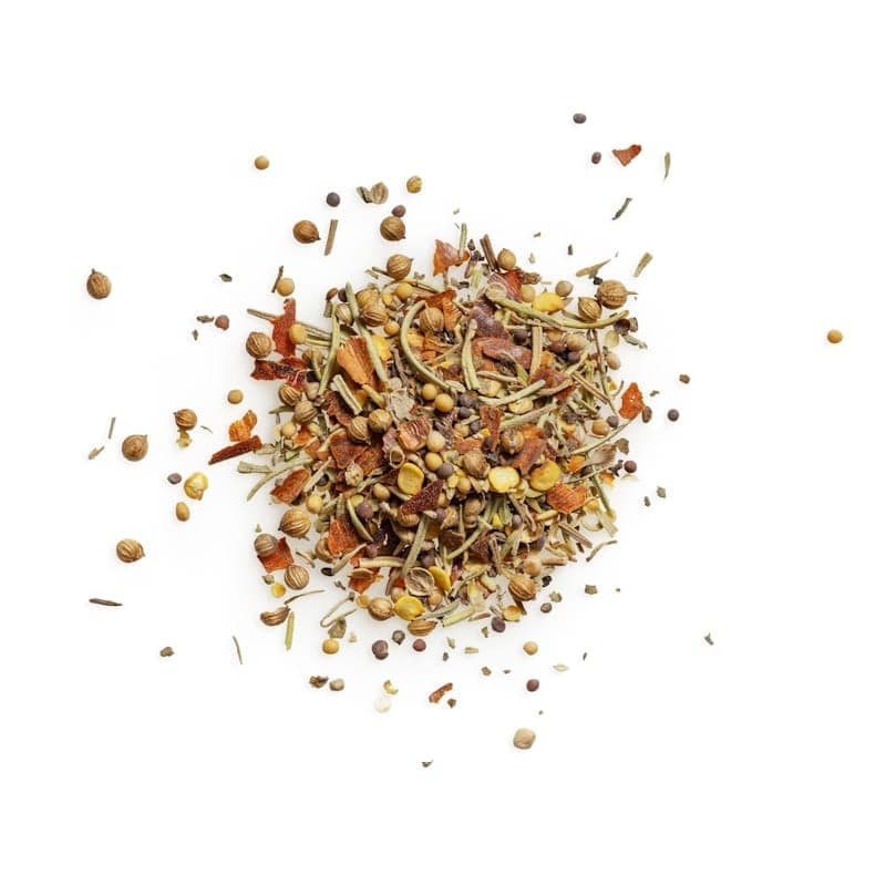A loose heap of dark barbecue rub with visible pepper and herb flecks