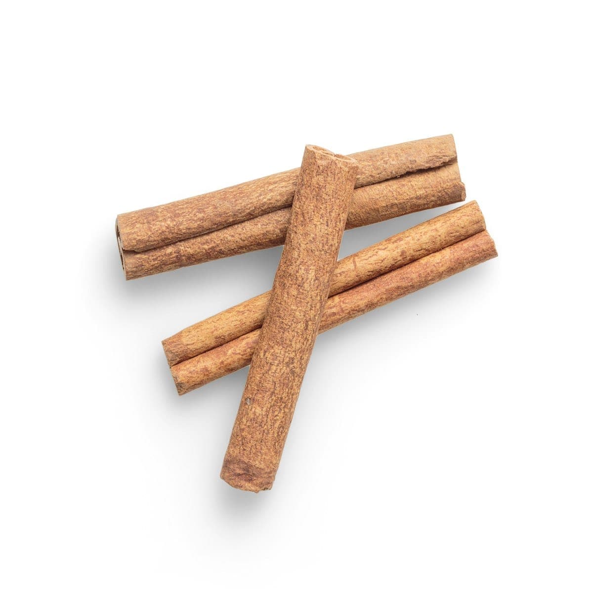 True Ceylon cinnamon quills crossed on a white surface