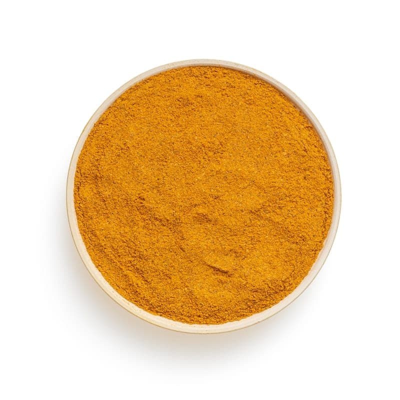 A ceramic bowl filled with vivid orange chile powder