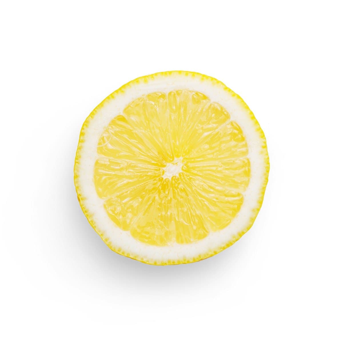 A dried lemon slice glowing against a white background