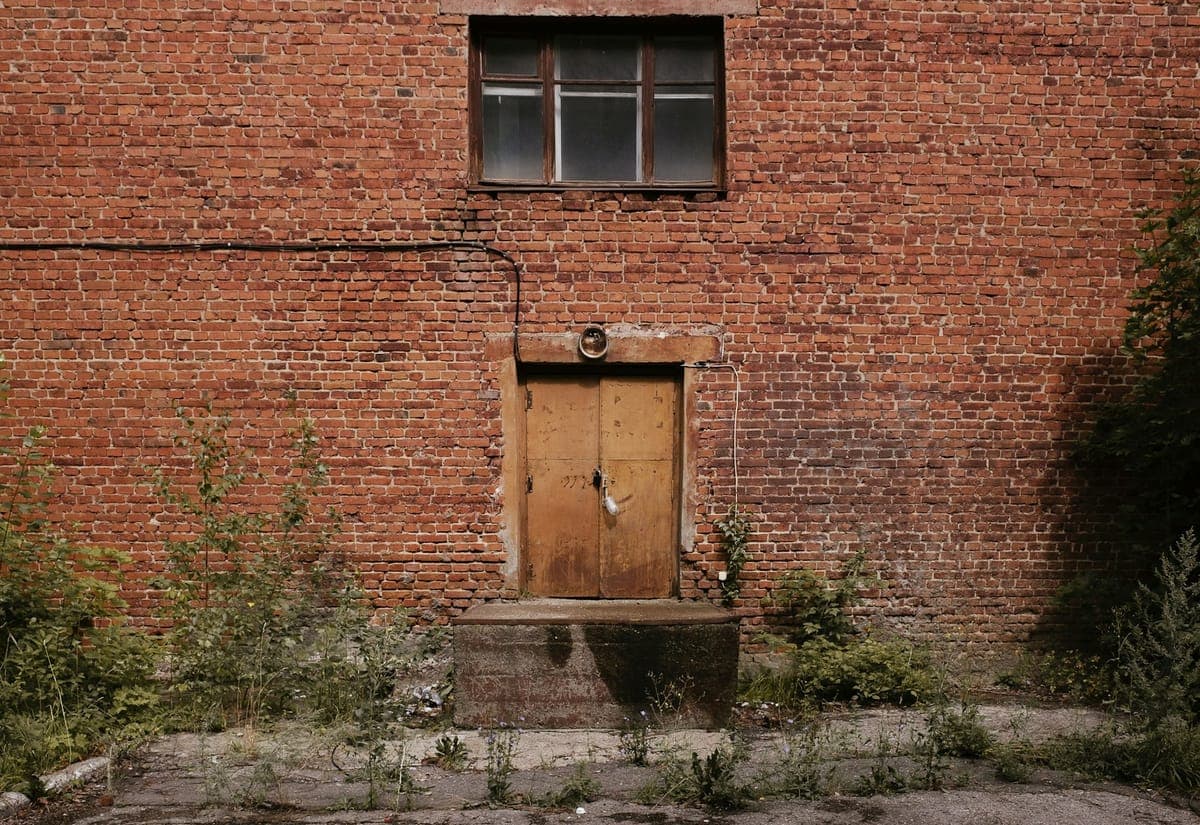 A weathered brick warehouse facade in the West Bottoms